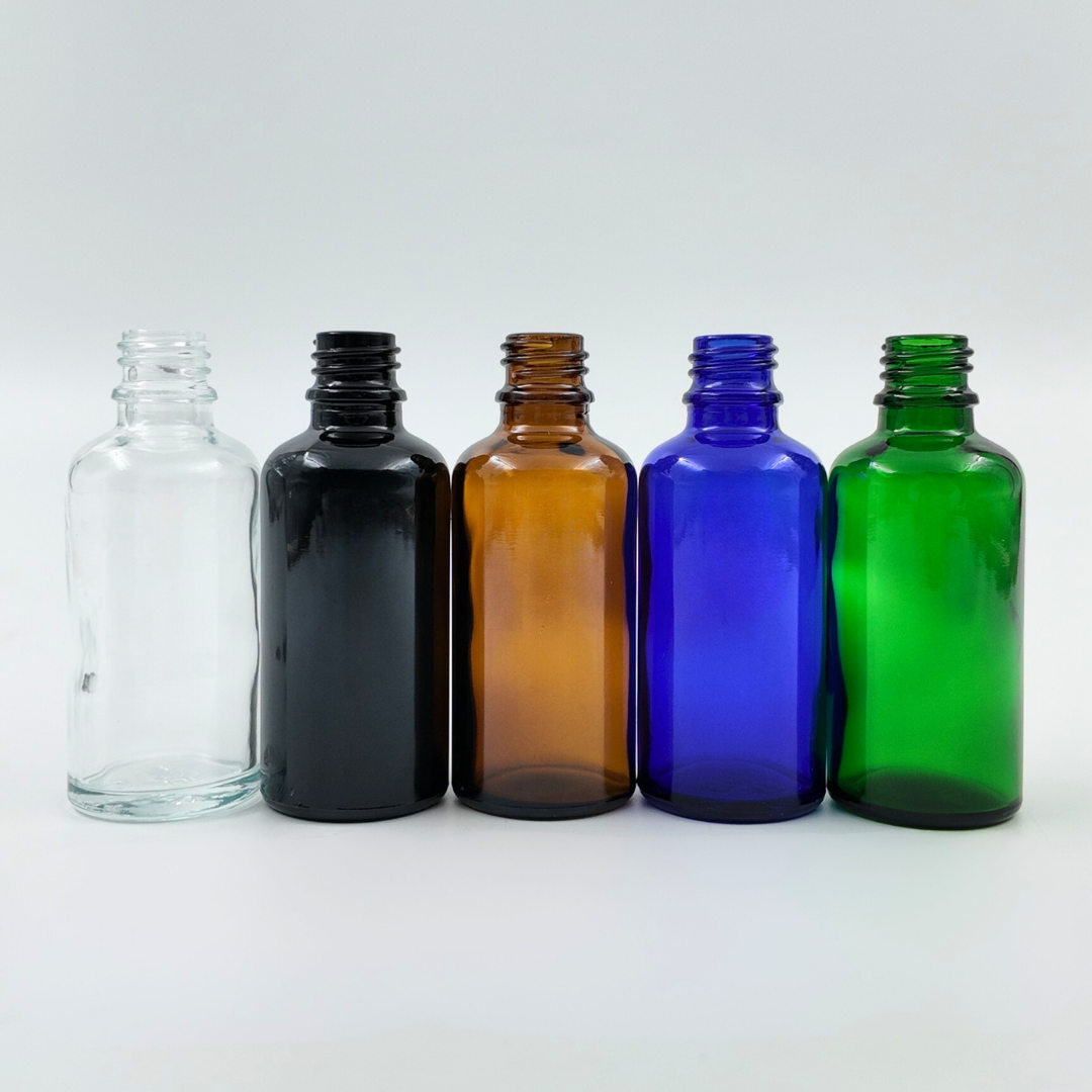 Set of 50ml glass bottles in clear, black, amber, blue, and green arranged side by side on a white background.