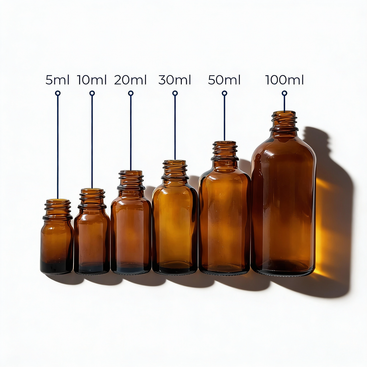 collection of amber glass dropper bottles, empty cosmetic packaging for serums, oils and skincare formulations