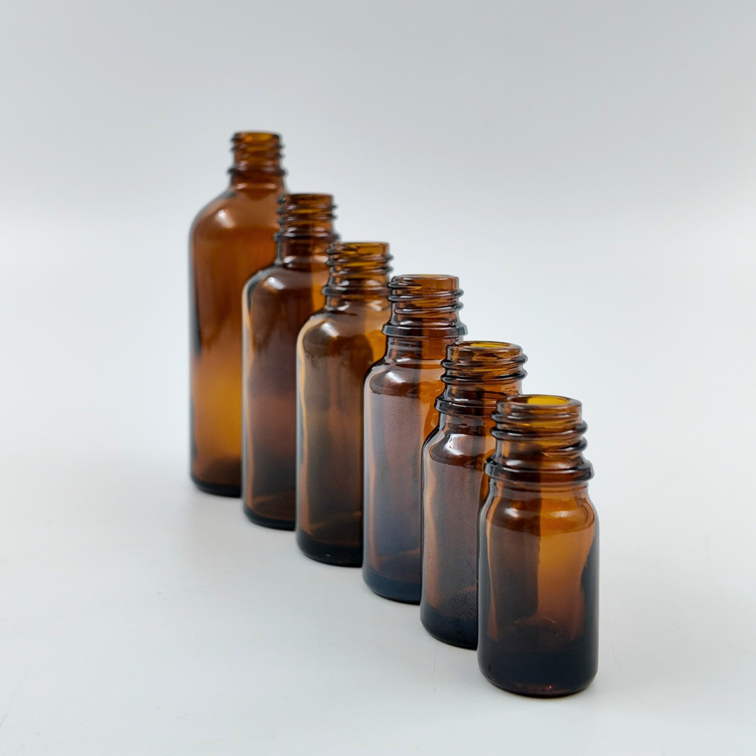 Set of amber glass bottles in different sizes displayed together