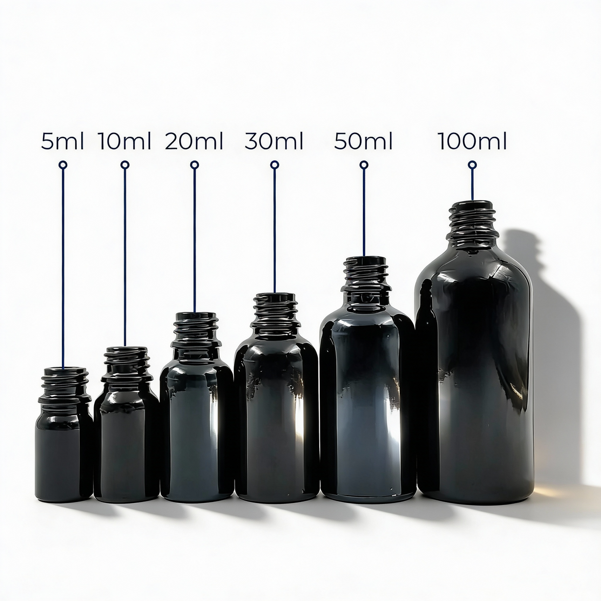 Collection of black glass dropper bottles, empty cosmetic packaging for serums, oils and skincare formulations