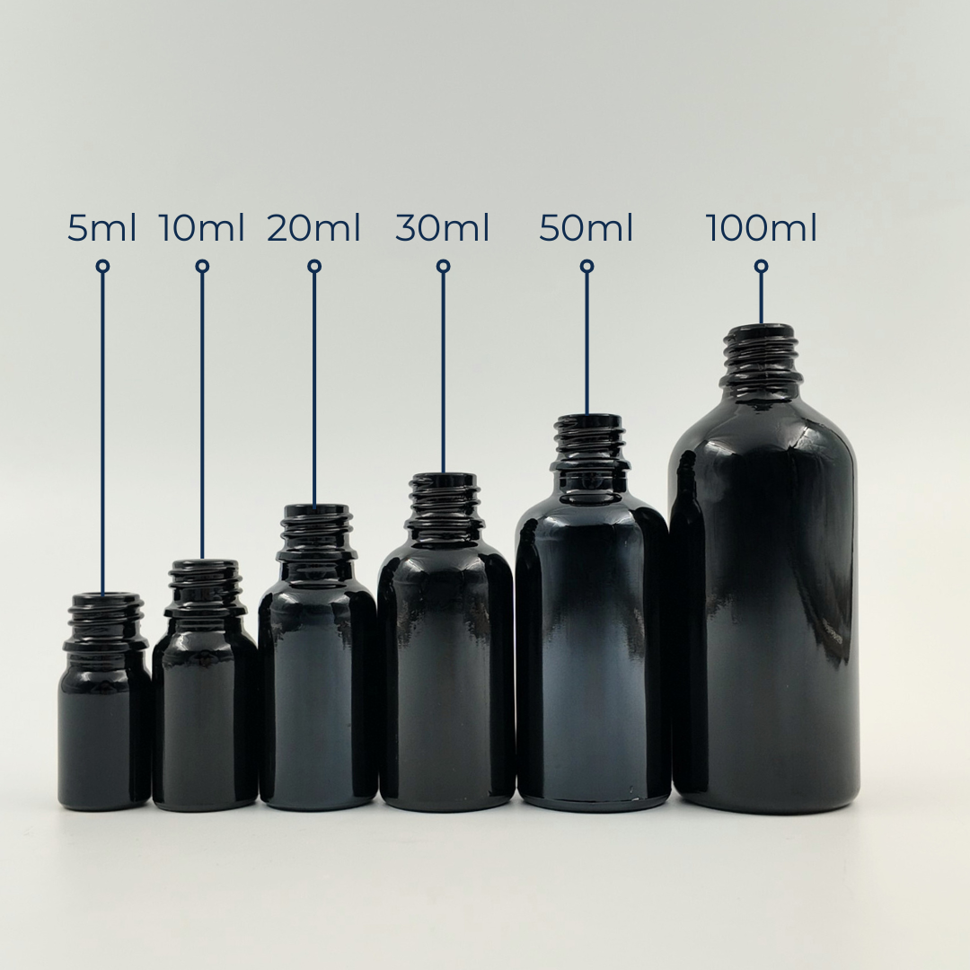 Set of black glass bottles in assorted sizes displayed together