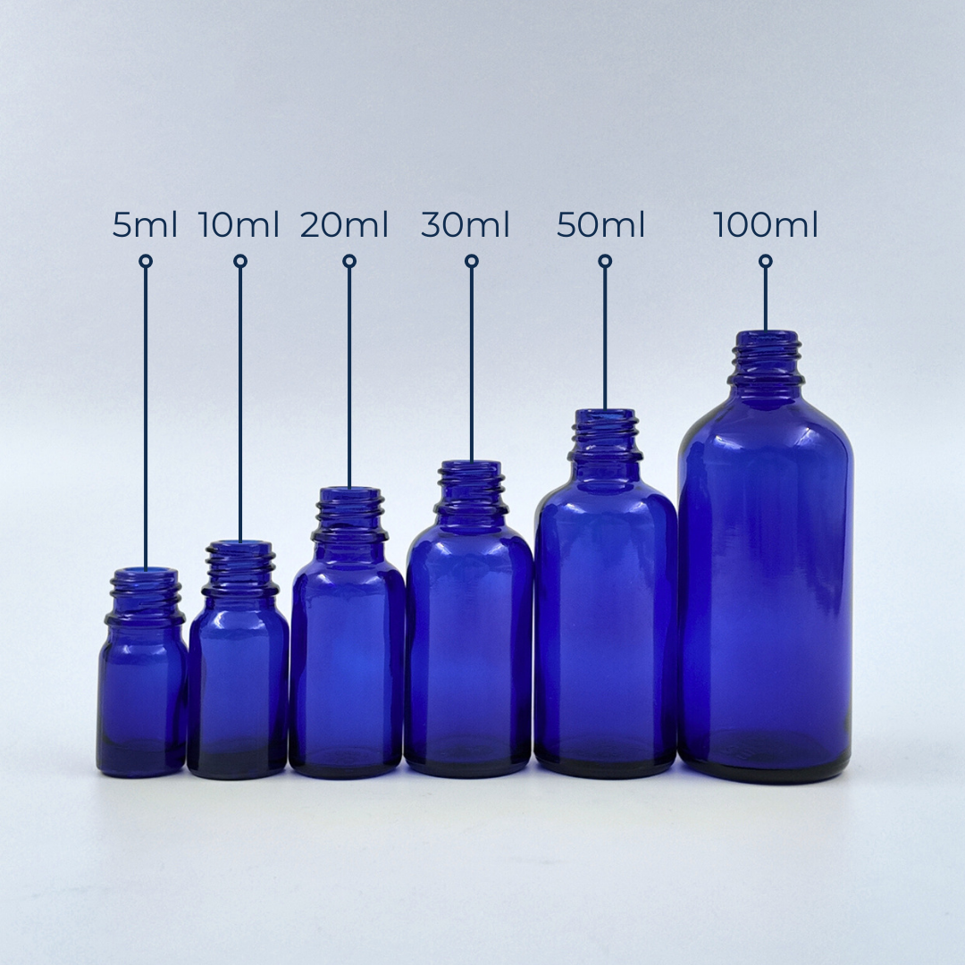 Set of blue glass bottles in assorted sizes displayed together