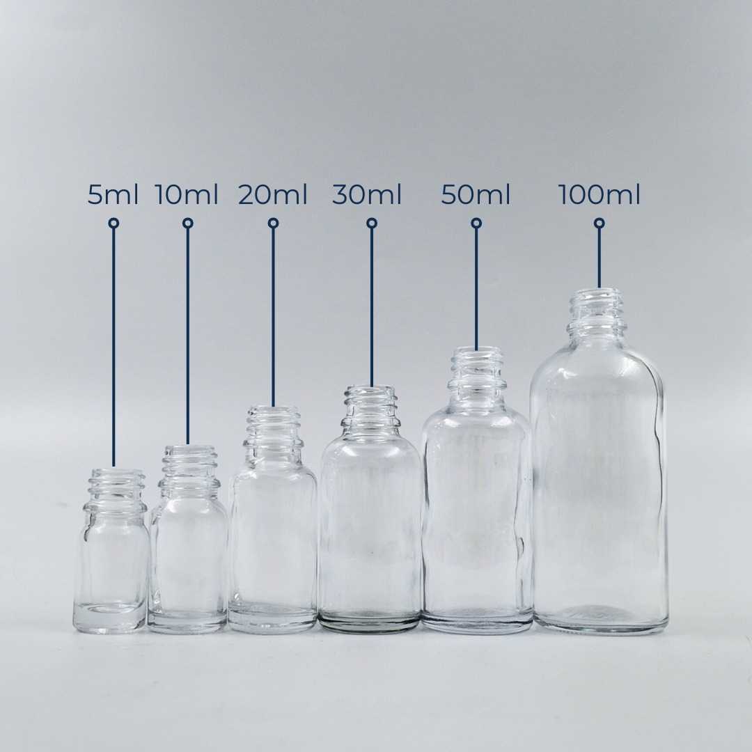 Set of clear glass bottles in assorted sizes displayed together