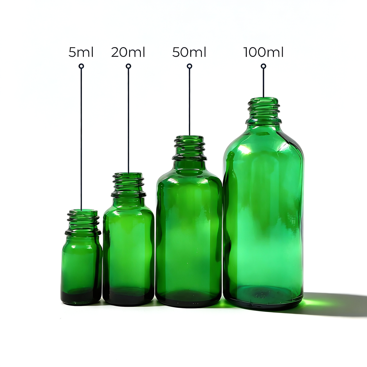 Collection of green glass dropper bottles, empty cosmetic packaging for serums, oils and skincare formulations
