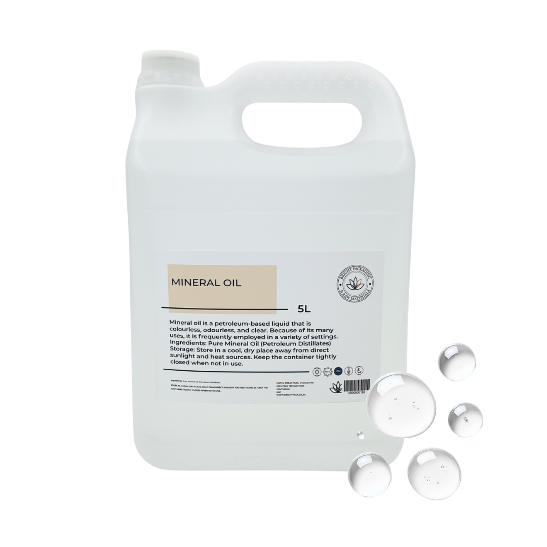 5 liter container of mineral oil with a label, and drops of mineral oil on a white background