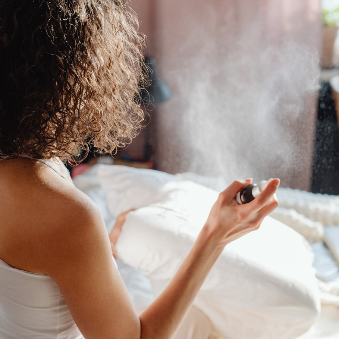 A Brightpack Linen & Room Mist Base being sprayed onto bedding, curtains, or into the air, showcasing its versatile use in home, spa, and hospitality settings.