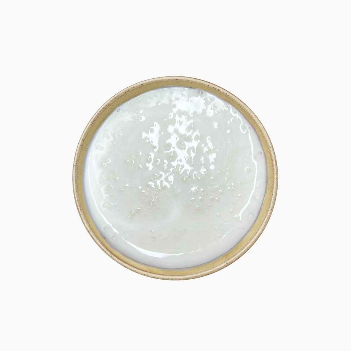 A white, pearlised, viscous liquid with a shimmering, opalescent appearance, contained in a smooth, glossy surface. The texture appears thick and uniform, reflecting light to create a subtle pearlescent effect.