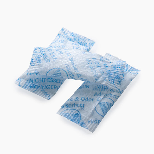 Three Stacked Small Packets Of Silica Gel On White Background | Brightpack Closures And Accessories