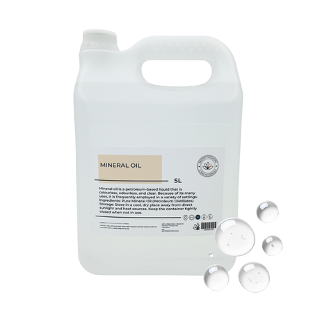 5 liter container of mineral oil with a label, and drops of mineral oil on a white background