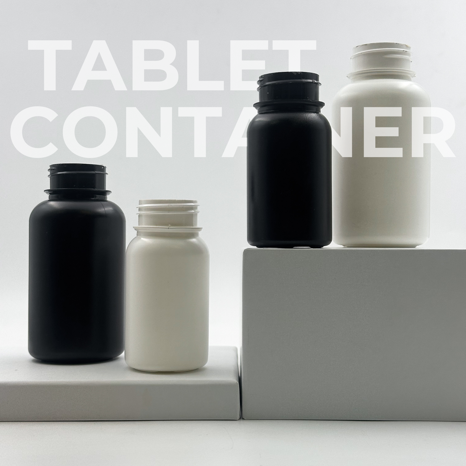 Tablet containers in black and white, both without closures.